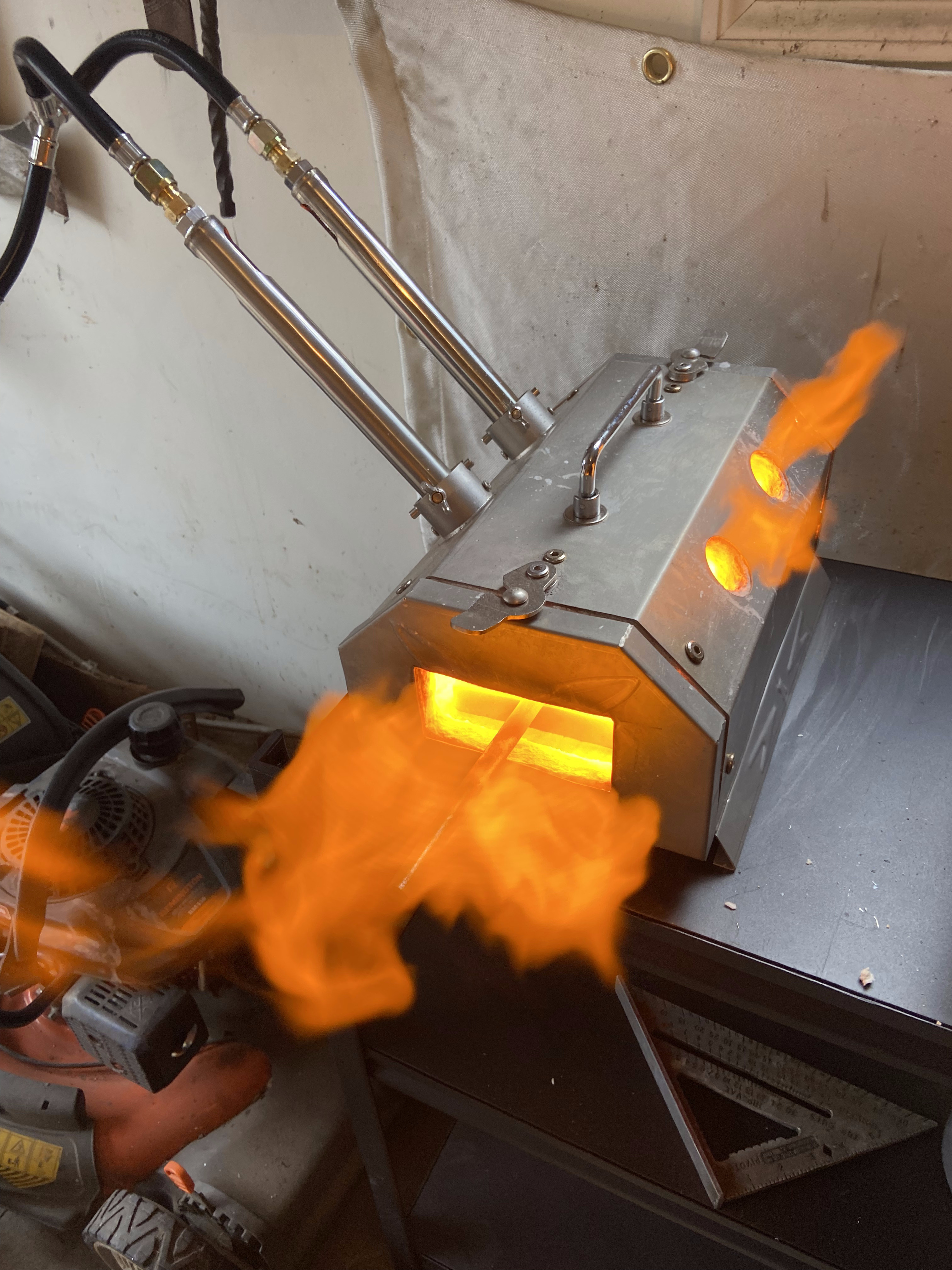 Propane forge roaring with orange flames — blacksmithing