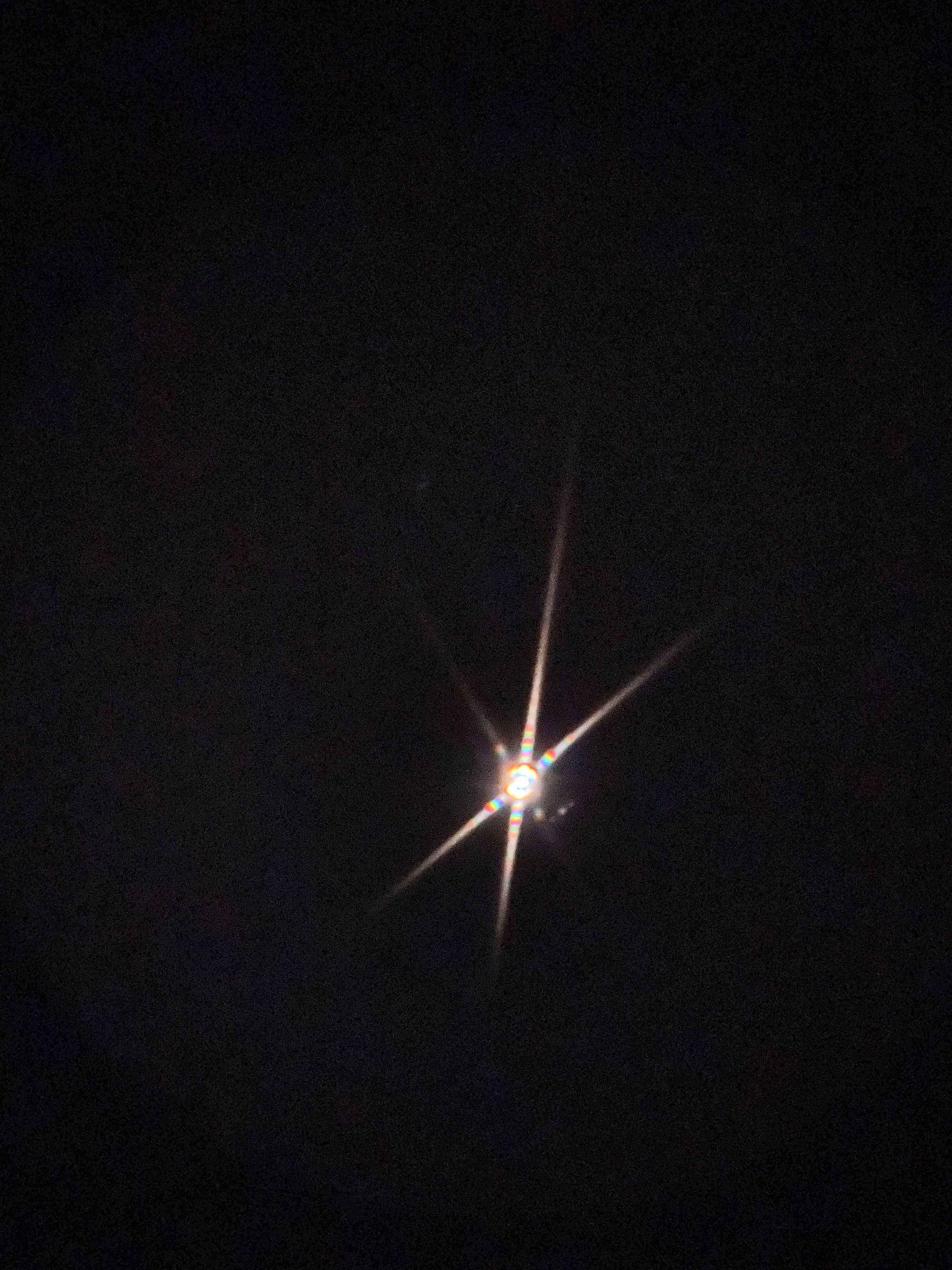 Bright star imaged through the completed telescope — sharp diffraction spikes on black sky, confirming collimation