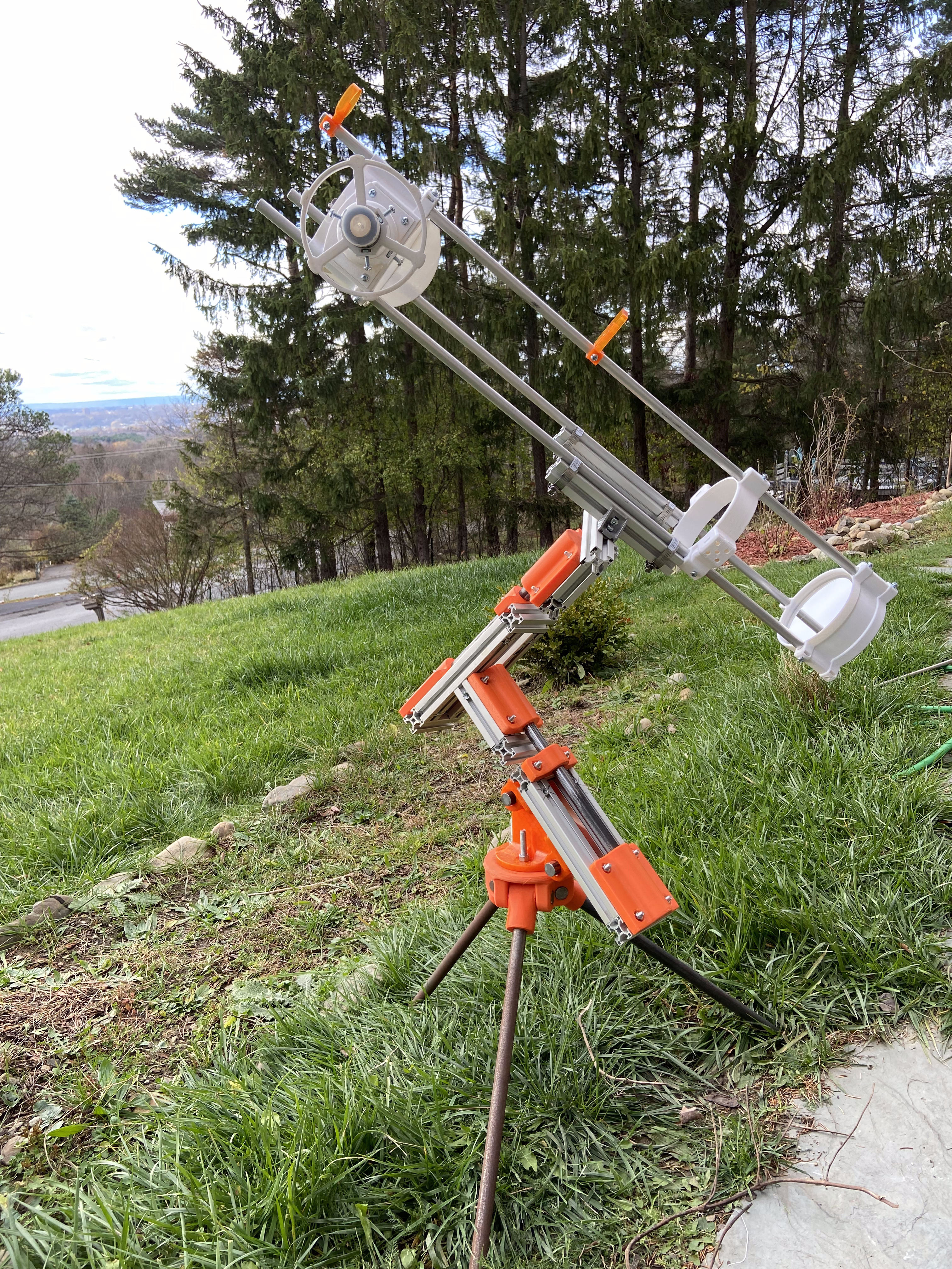 3D-printed equatorial telescope mount assembled outdoors on a hillside