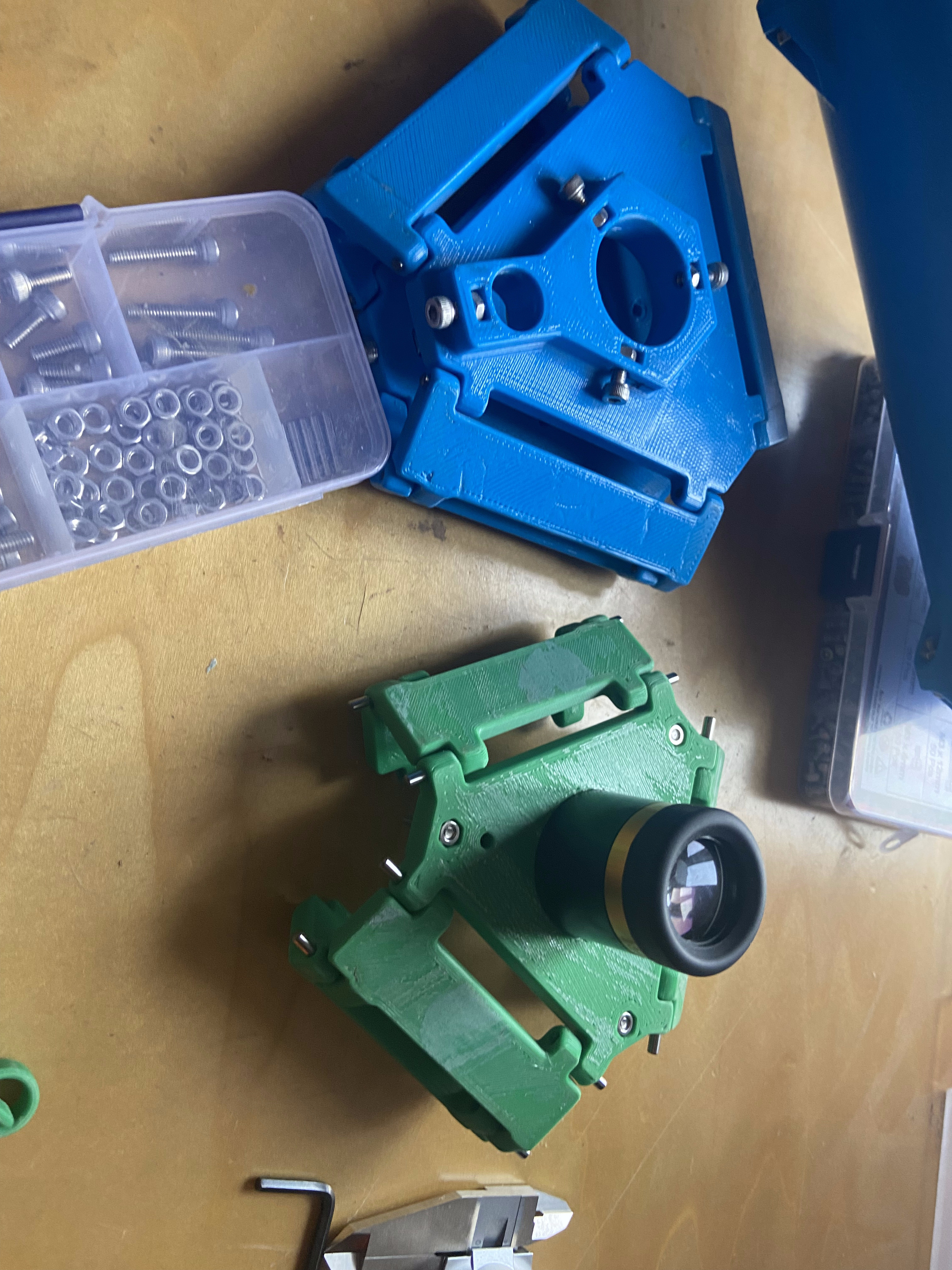 Focuser assembly and mirror cell components laid out on a workbench before final assembly