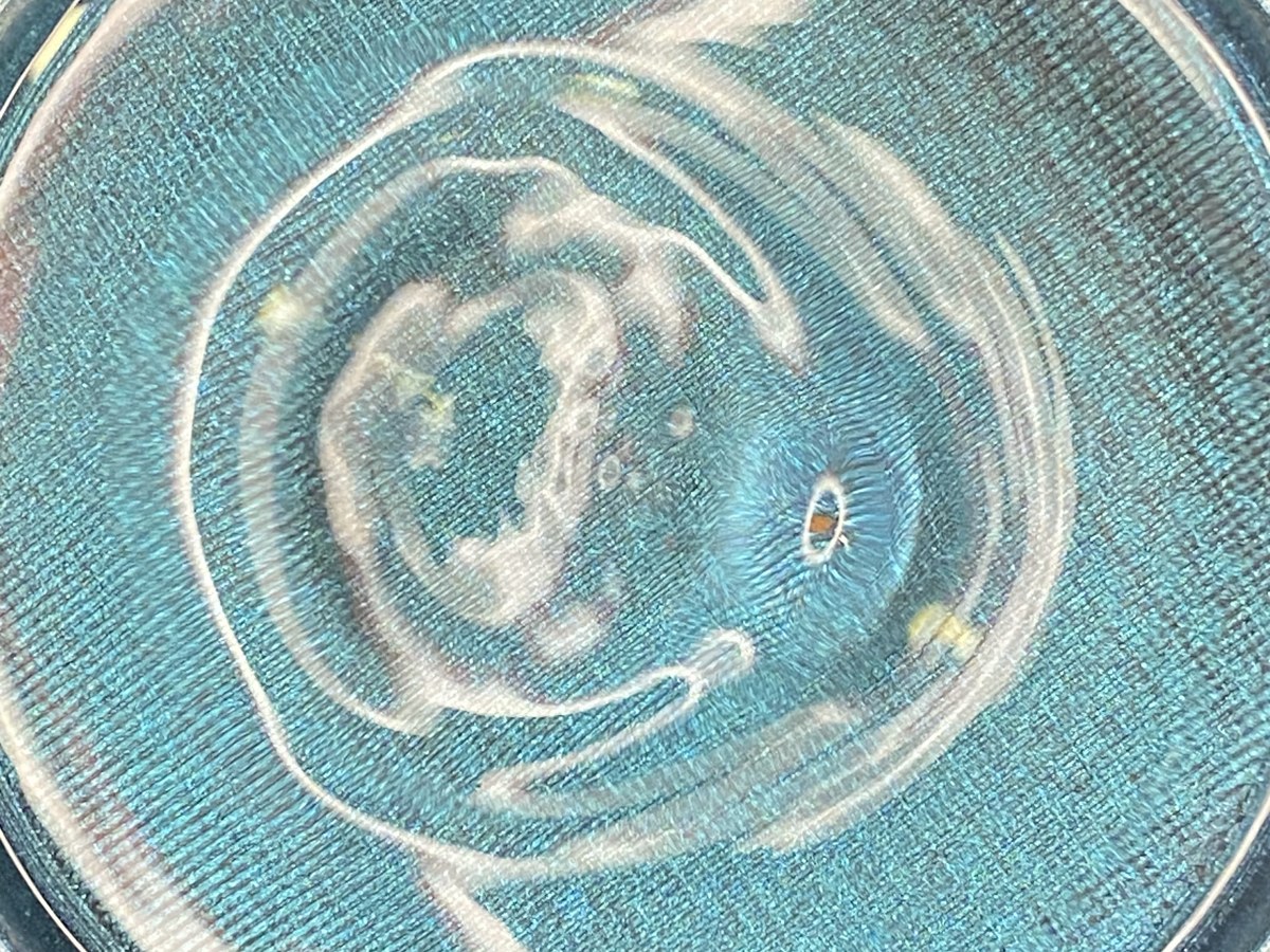 Asymmetric Chladni figure in blue powder — complex irregular modal pattern