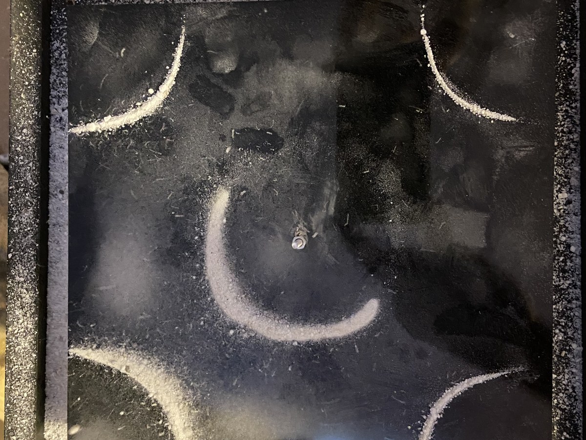 Arcing sand Chladni pattern showing curved nodal lines