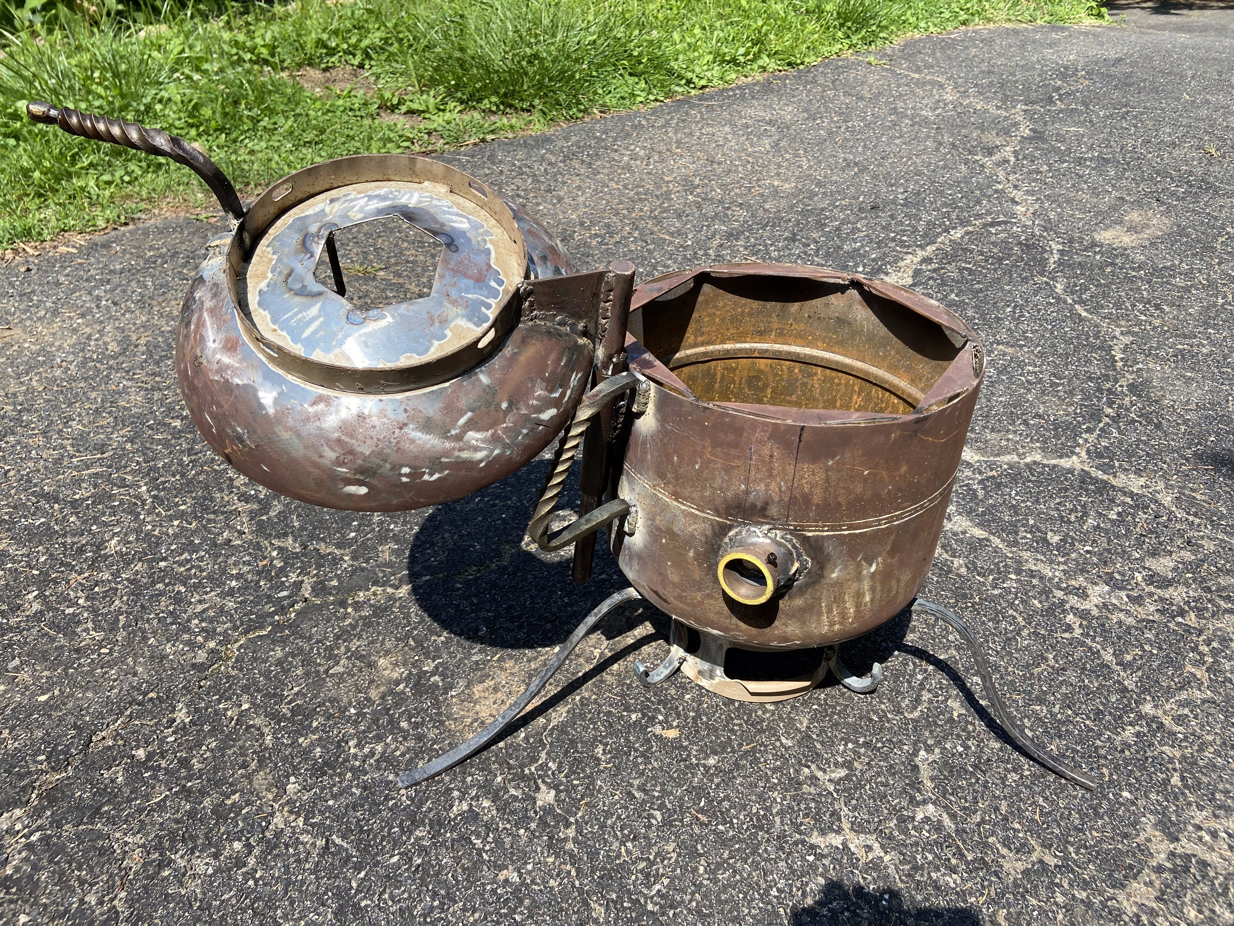 Completed furnace assembly with domed lid, steel legs, and burner port