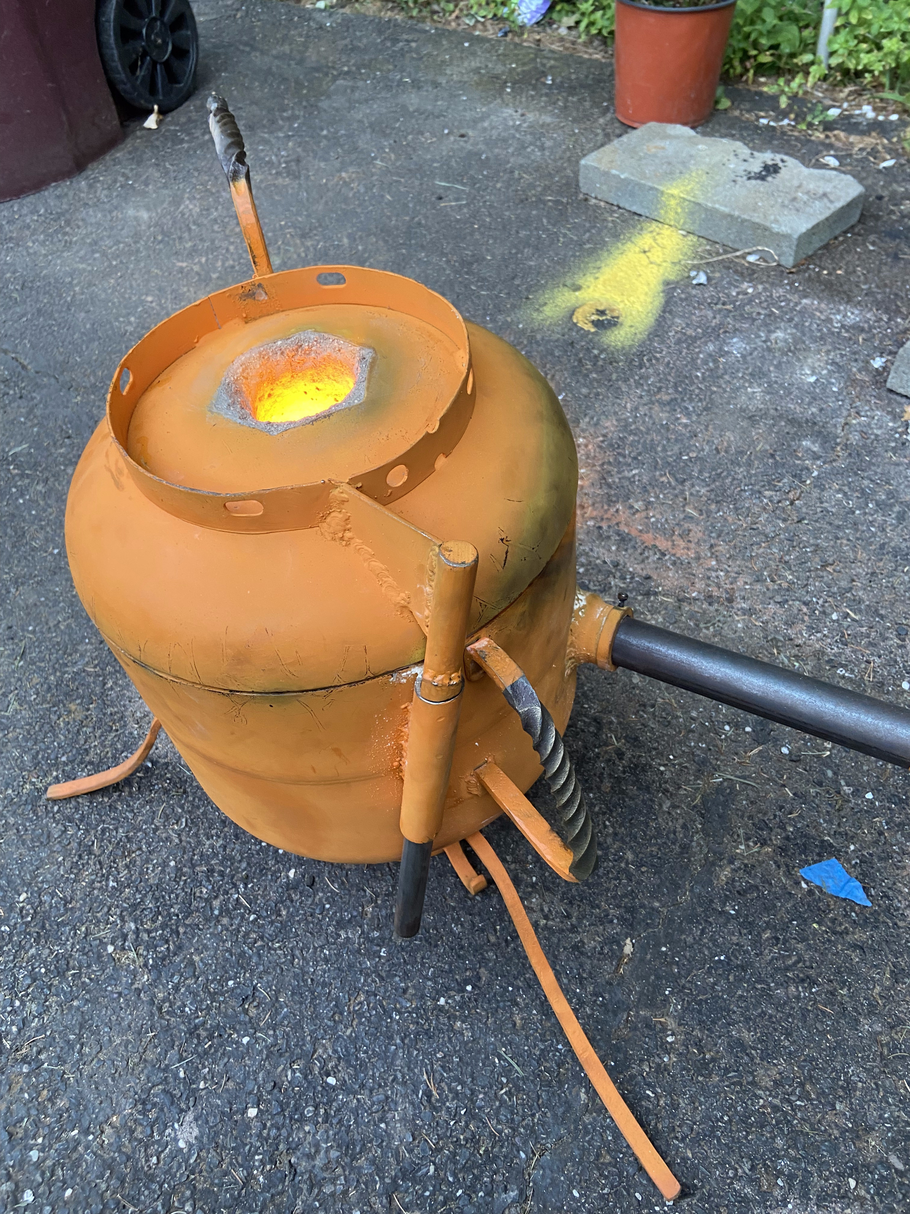 Top-down view of furnace during firing — glowing orange vent port